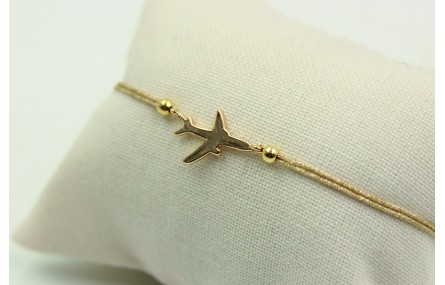 Pulsera de macrame en color oro palido y avión dor