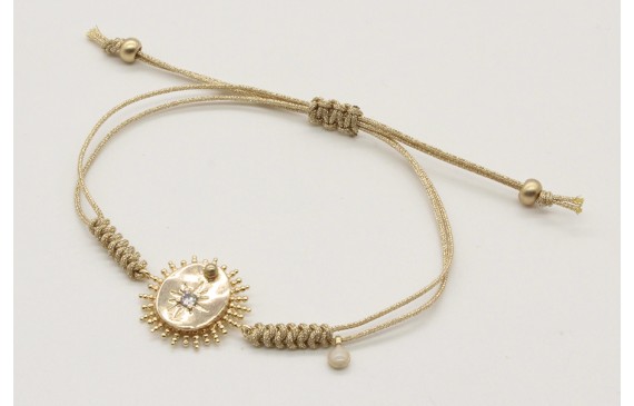 Pulsera nudo serpiente en oro palido con sol y dis
