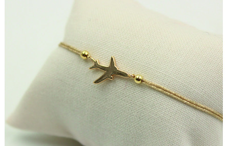 Pulsera de macrame en color oro palido y avión dor