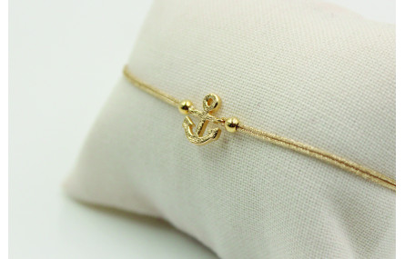 Pulsera de macrame en color oro palido y ancla dor