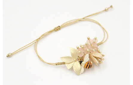 Pulsera nudo serpiente oro pálido con centro hoja 